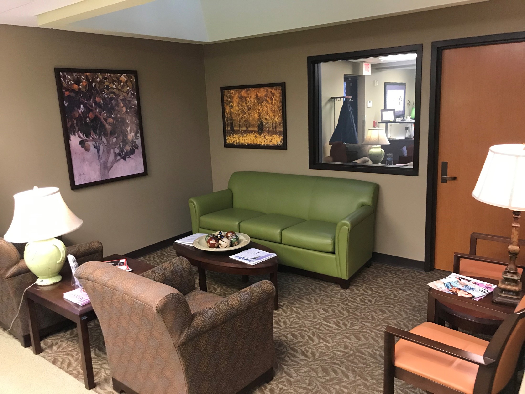 Waiting area with green couch.