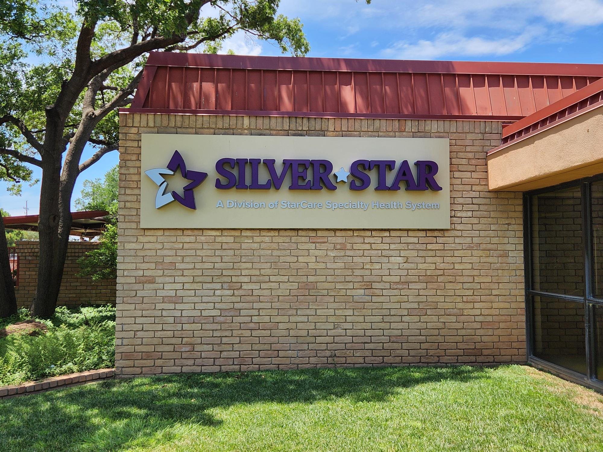 Silver Star health sign on brick building.