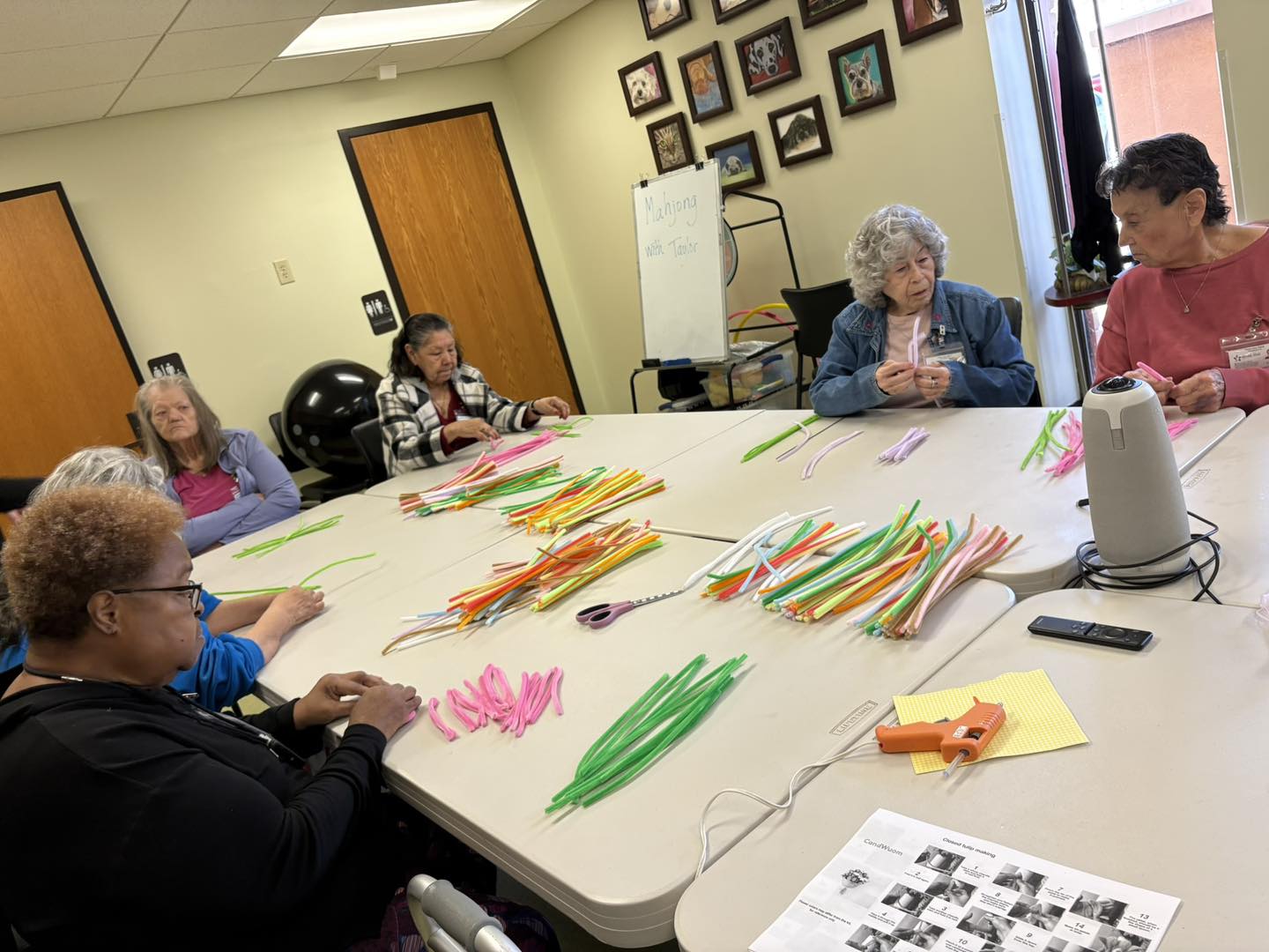 Elderly group crafting with colorful materials.